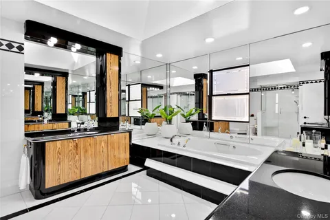 a large white kitchen with a large window