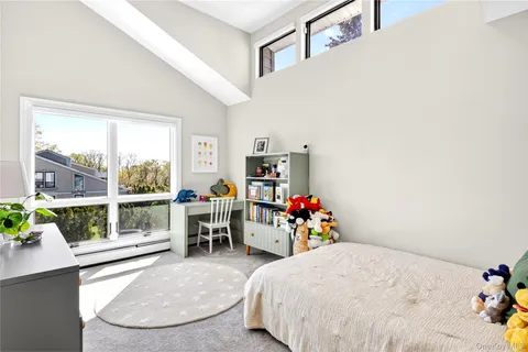 a bed room with a bed window and flowerpot