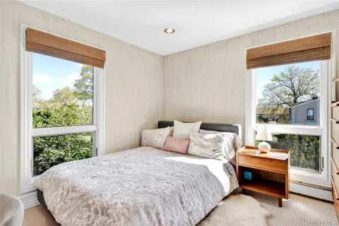 a bedroom with a bed and window