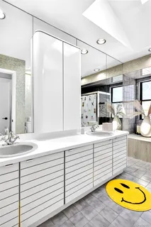 a bathroom with a sink double vanity and a mirror