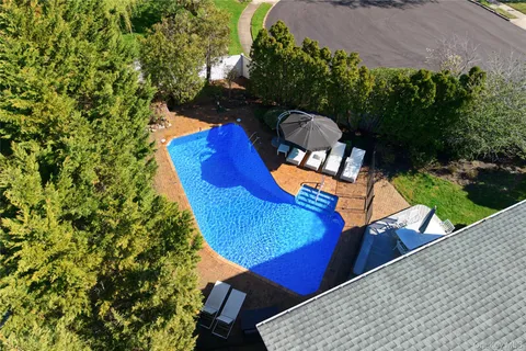 an aerial view of a house with a yard and sitting area