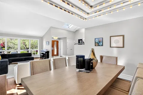 a living room with furniture a flat screen tv and a large window