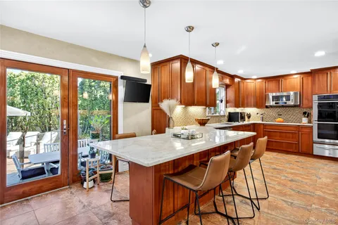a kitchen with a table chairs sink and refrigerator
