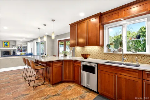 a kitchen with stainless steel appliances granite countertop a sink and wooden cabinets
