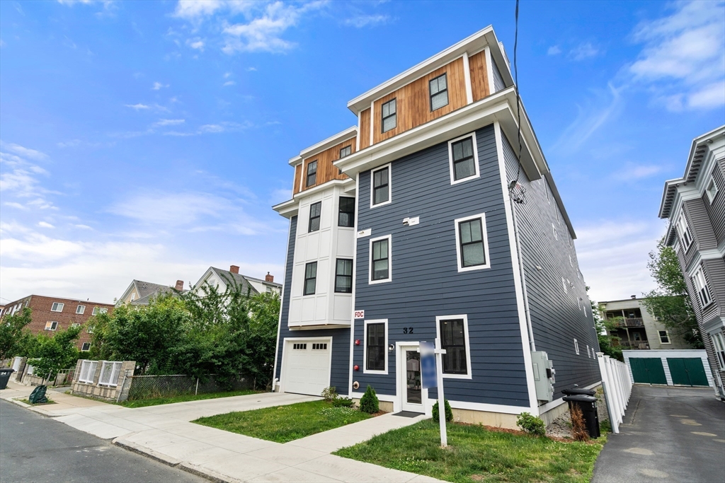 32 Pearl Street, Unit 4 Boston, MA 02125 - Photo 33 of 35 a front view of a house with a yard