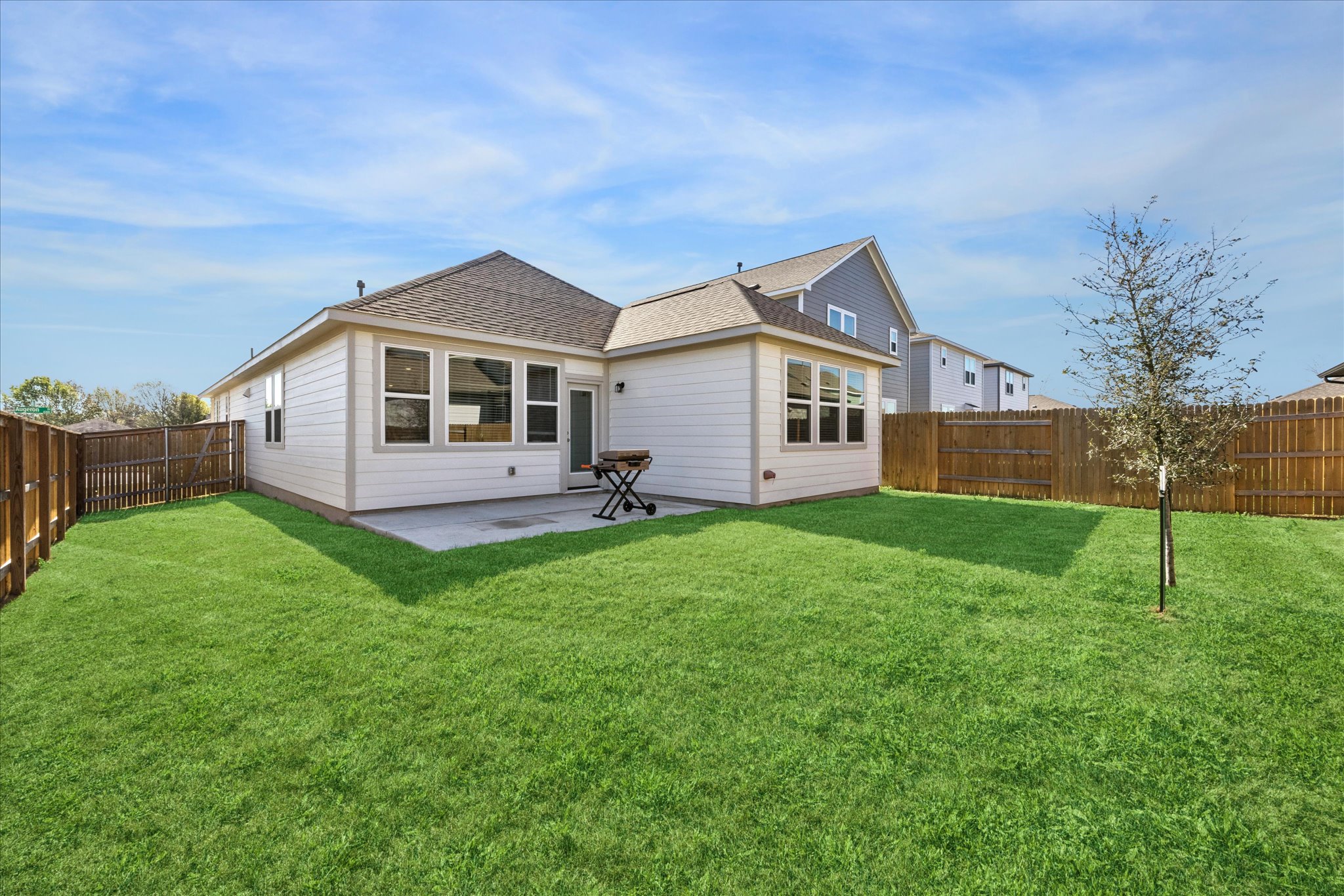 8300 Augeron Drive Austin, TX 78747 - Photo 14 of 16 Rear view of property featuring a fenced backyard, a shingled roof, and a patio area