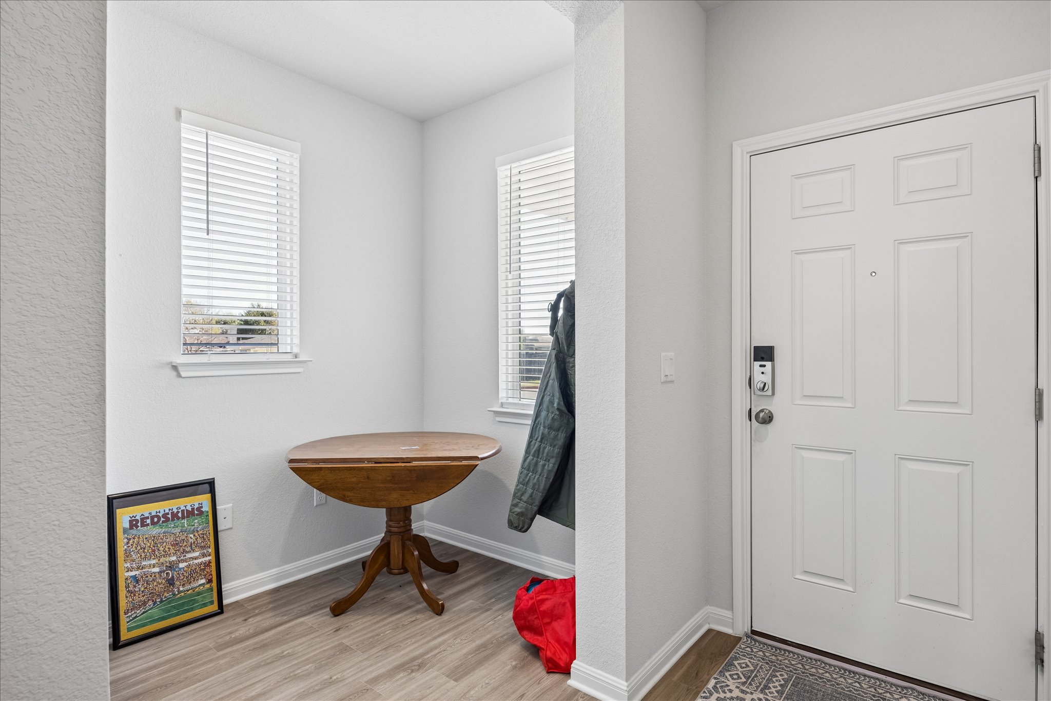 8300 Augeron Drive Austin, TX 78747 - Photo 2 of 16 Foyer entrance with light wood finished floors and a textured wall