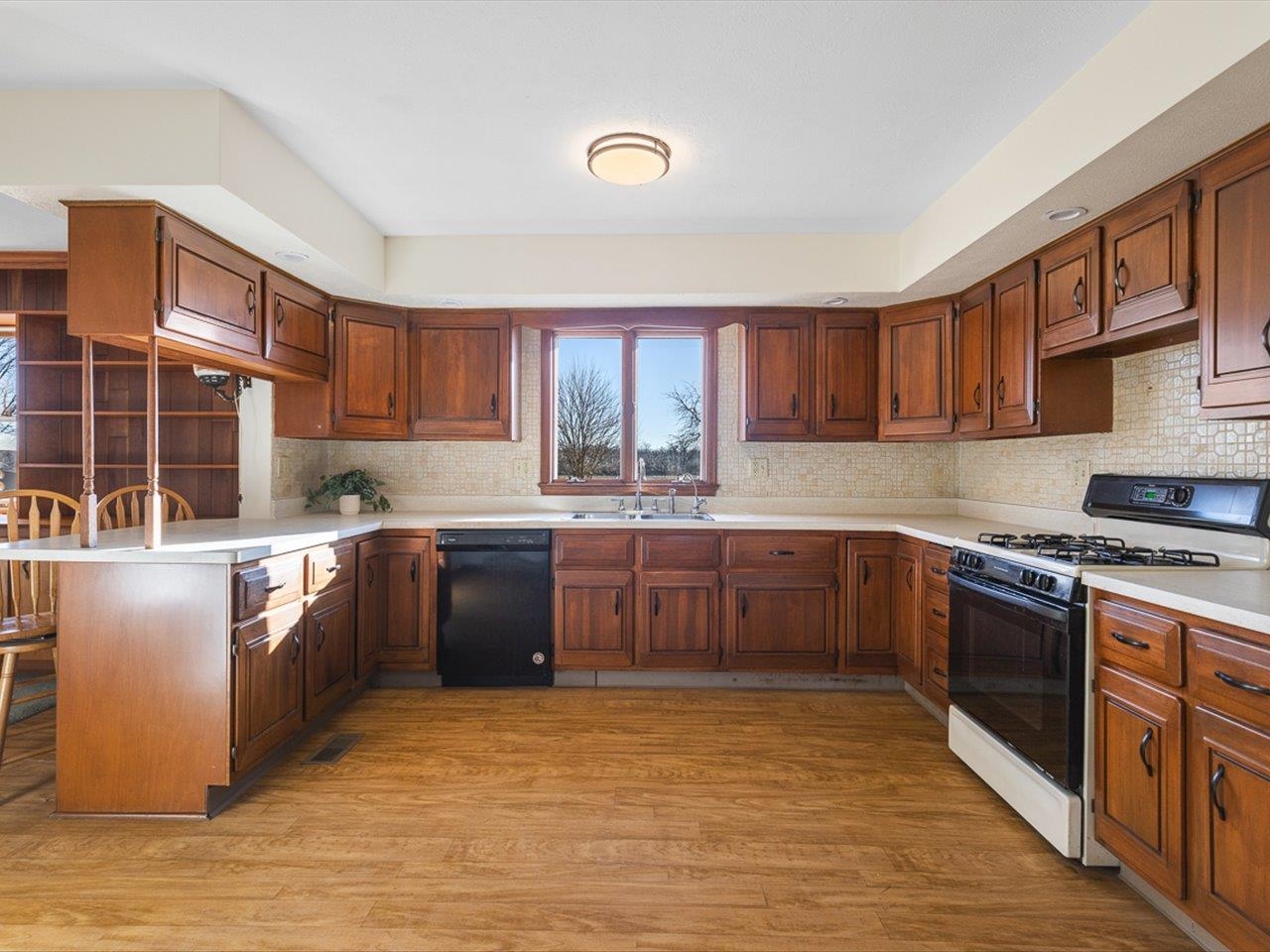 7101 Lawrenceville Road Garden Prairie, IL 61038 - Photo 15 of 53 a kitchen with stainless steel appliances granite countertop a stove sink and cabinets