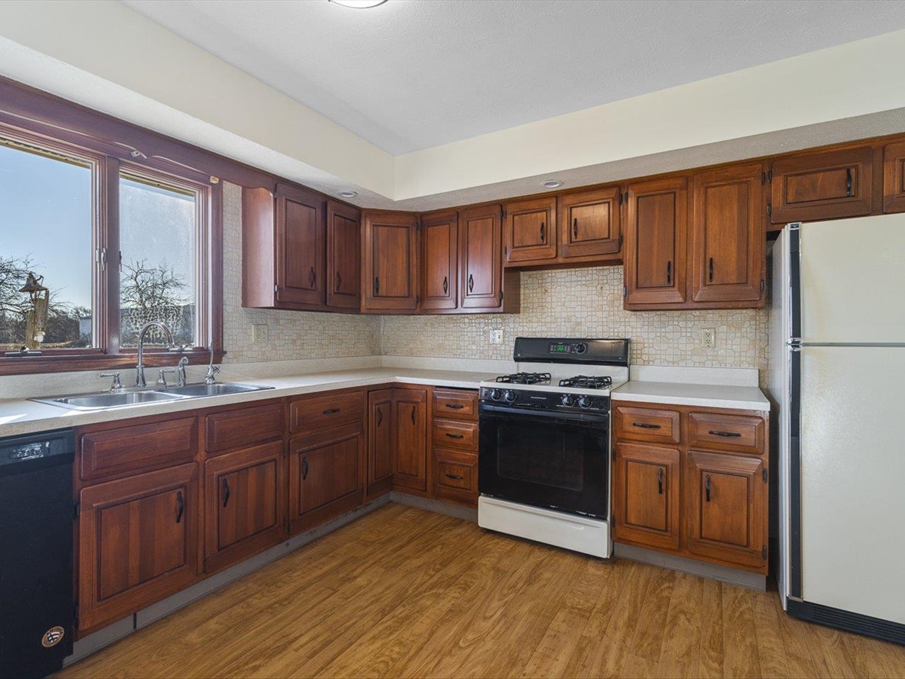 7101 Lawrenceville Road Garden Prairie, IL 61038 - Photo 16 of 53 a kitchen with stainless steel appliances granite countertop a stove a sink dishwasher and a refrigerator