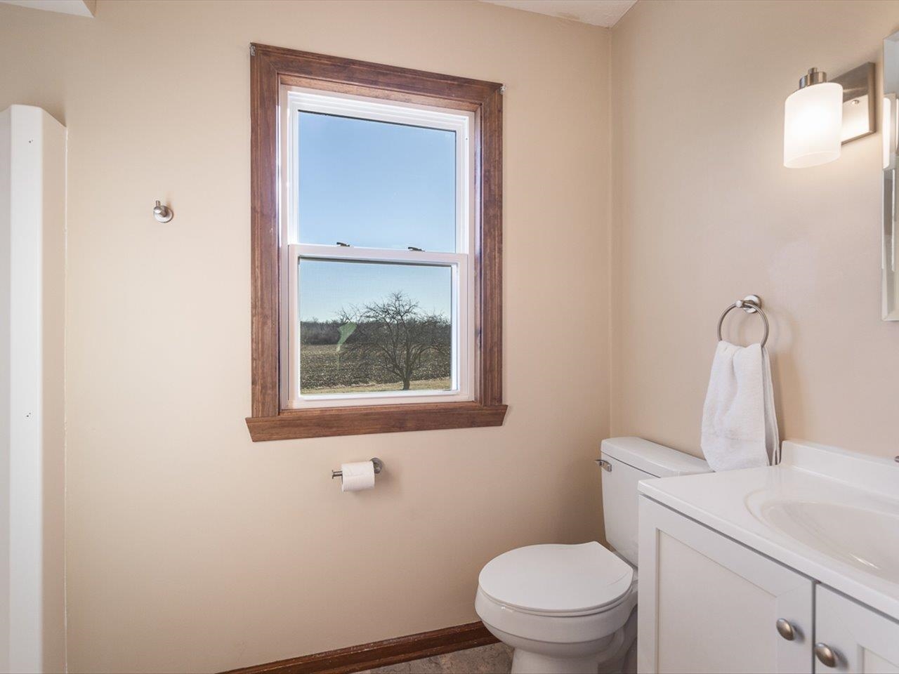 7101 Lawrenceville Road Garden Prairie, IL 61038 - Photo 31 of 53 a bathroom with a toilet sink and mirror
