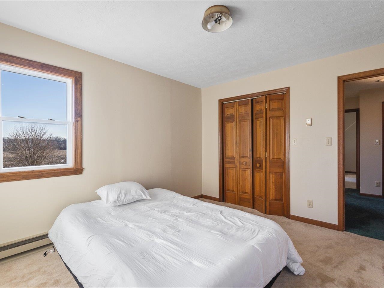 7101 Lawrenceville Road Garden Prairie, IL 61038 - Photo 34 of 53 a bedroom with a bed and a painting on the wall