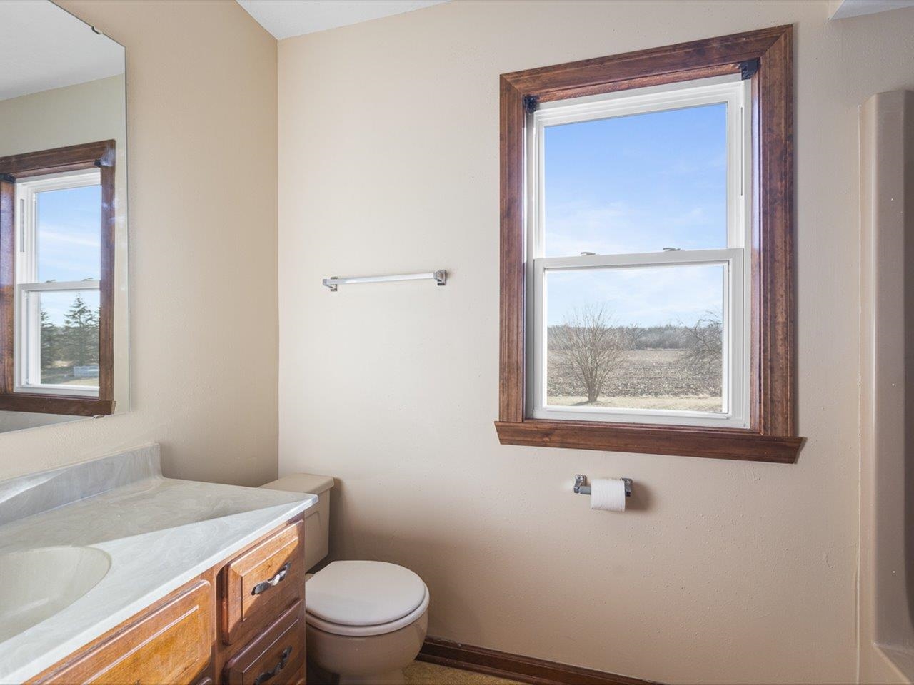 7101 Lawrenceville Road Garden Prairie, IL 61038 - Photo 37 of 53 a bathroom with a toilet a sink and mirror