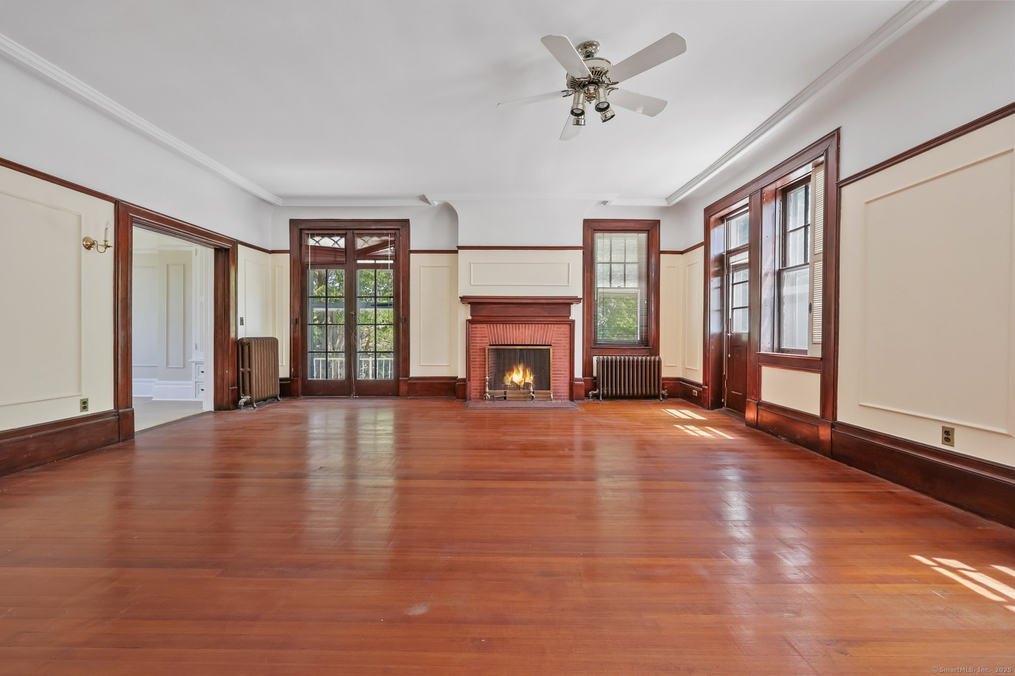 26 Shady Lane Greenwich, CT 06831 - Photo 23 of 29 wooden floor fireplace and windows in an empty room
