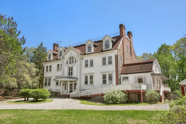 a front view of a house with a yard table and chairs
