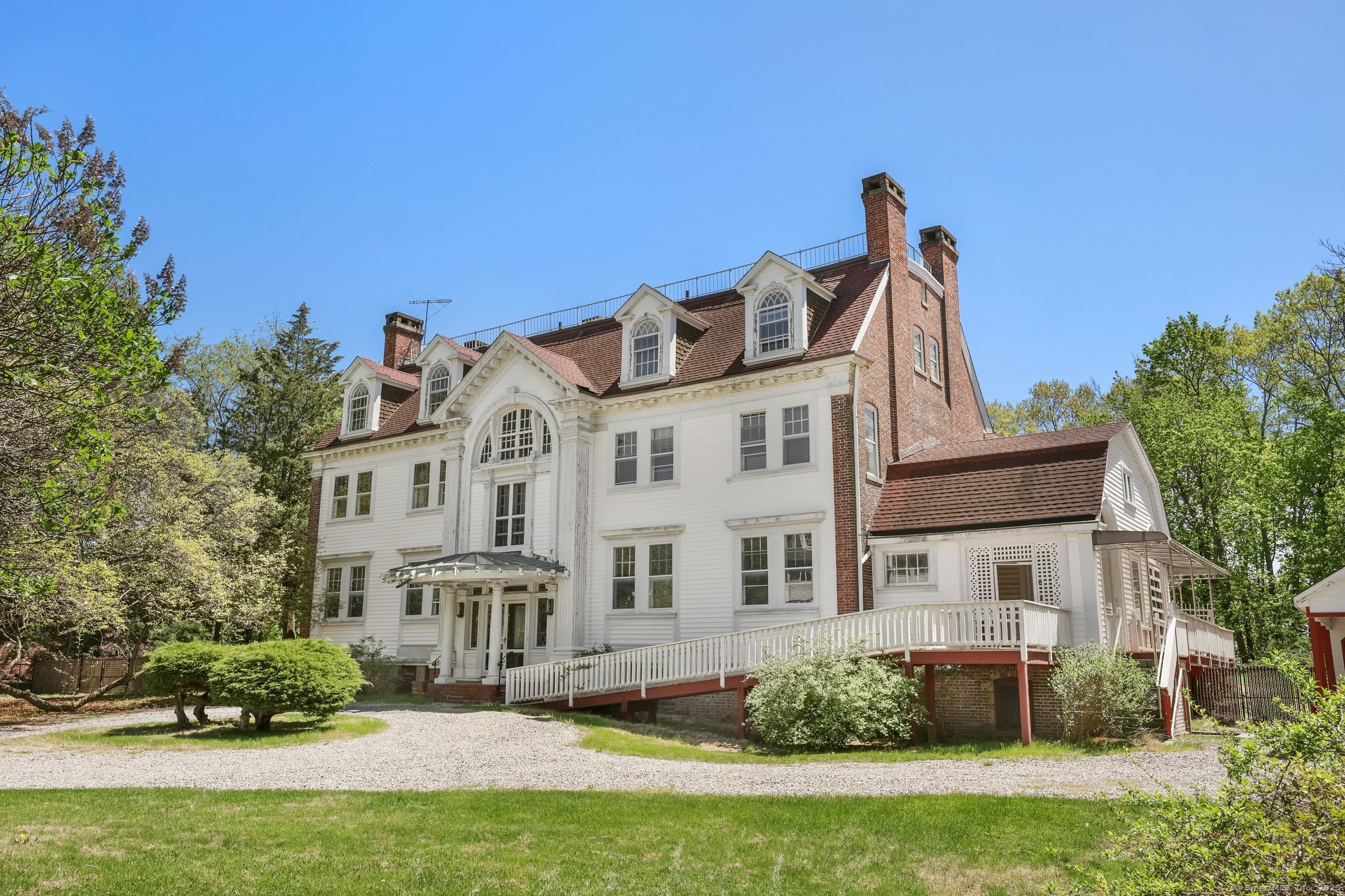 26 Shady Lane Greenwich, CT 06831 - Photo 26 of 29 a front view of a house with a garden
