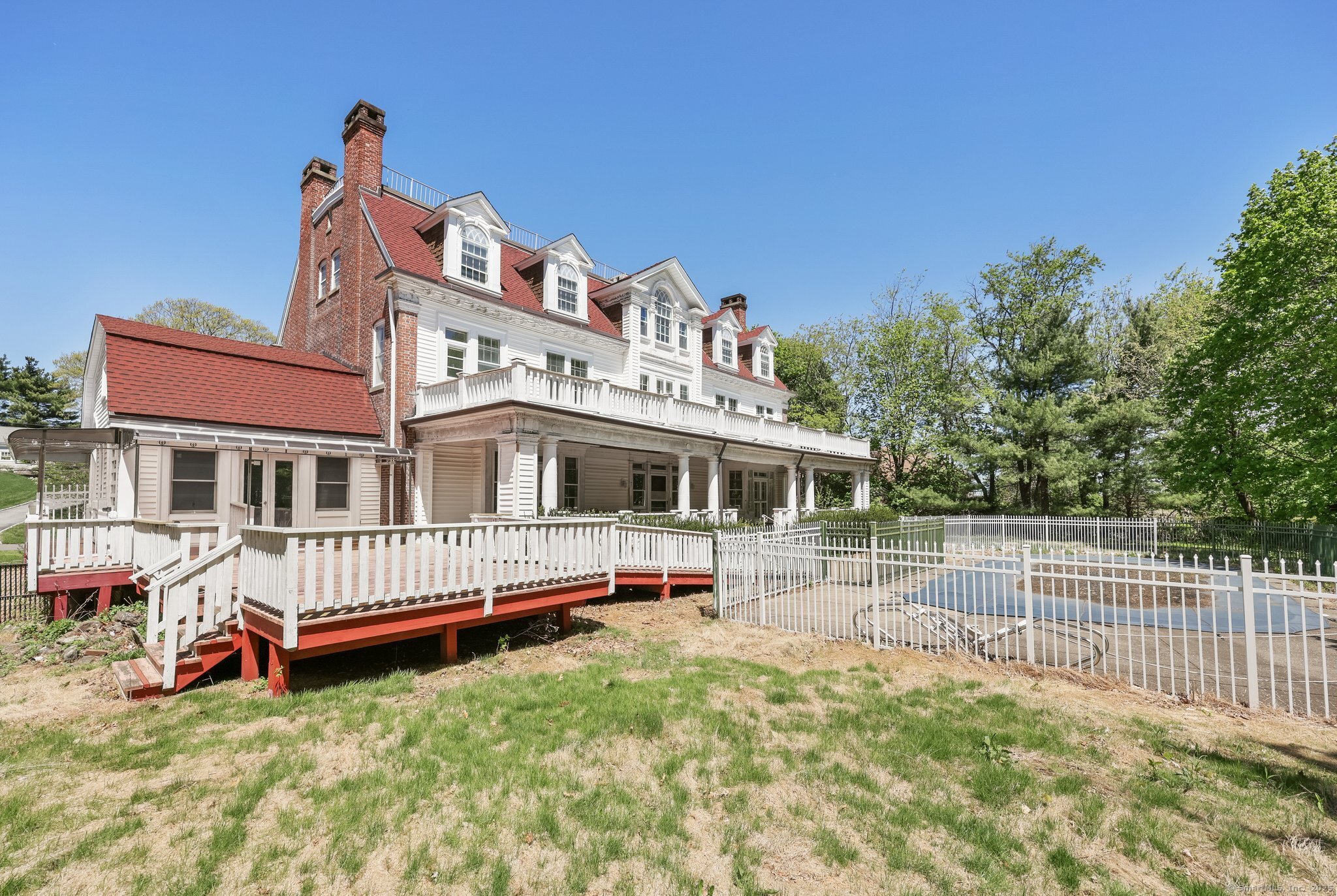 26 Shady Lane Greenwich, CT 06831 - Photo 27 of 29 a front view of a house with a yard table and chairs