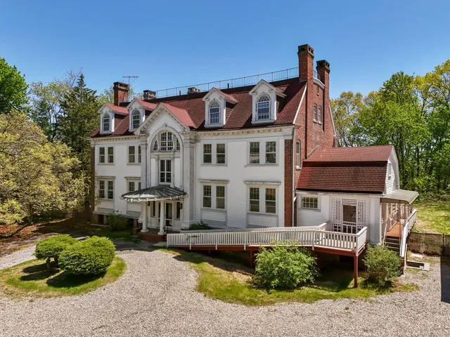 an aerial view of a house with a yard