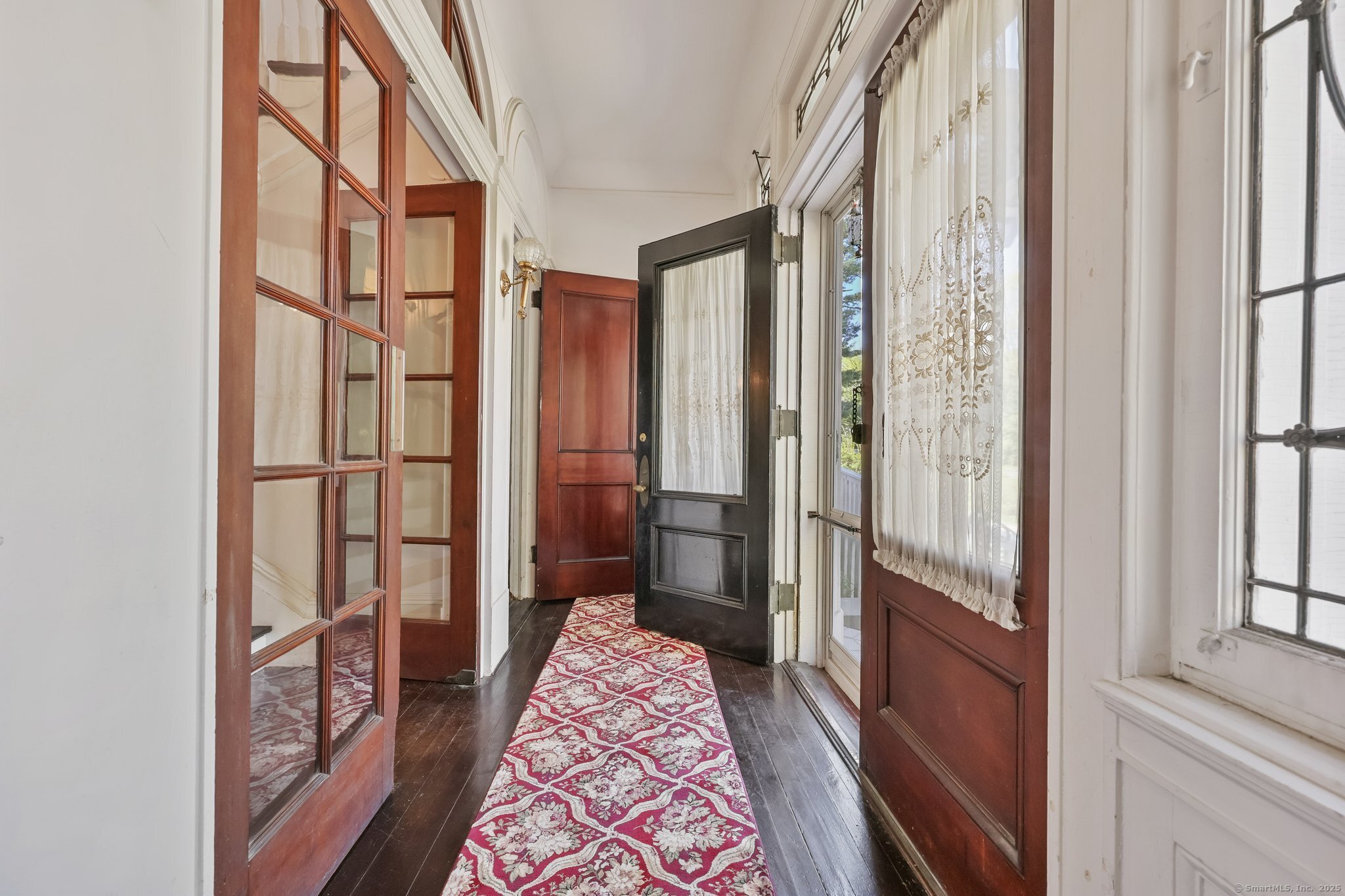 26 Shady Lane Greenwich, CT 06831 - Photo 3 of 29 a view of a hallway with a livingroom and wooden floor