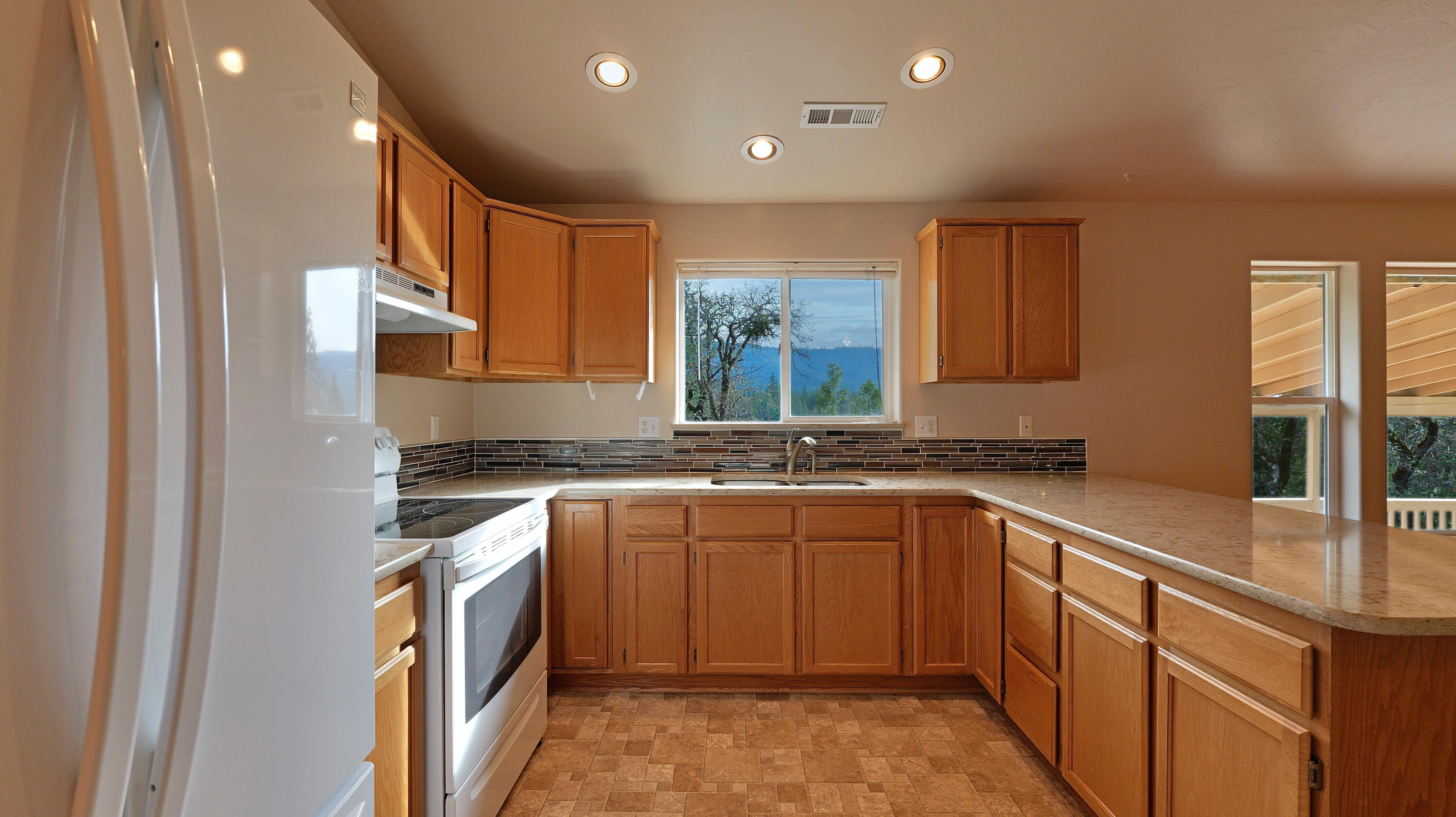 204 Shipley Terrace Prospect, OR 97536 - Photo 9 of 61 a kitchen with a sink stove and cabinets
