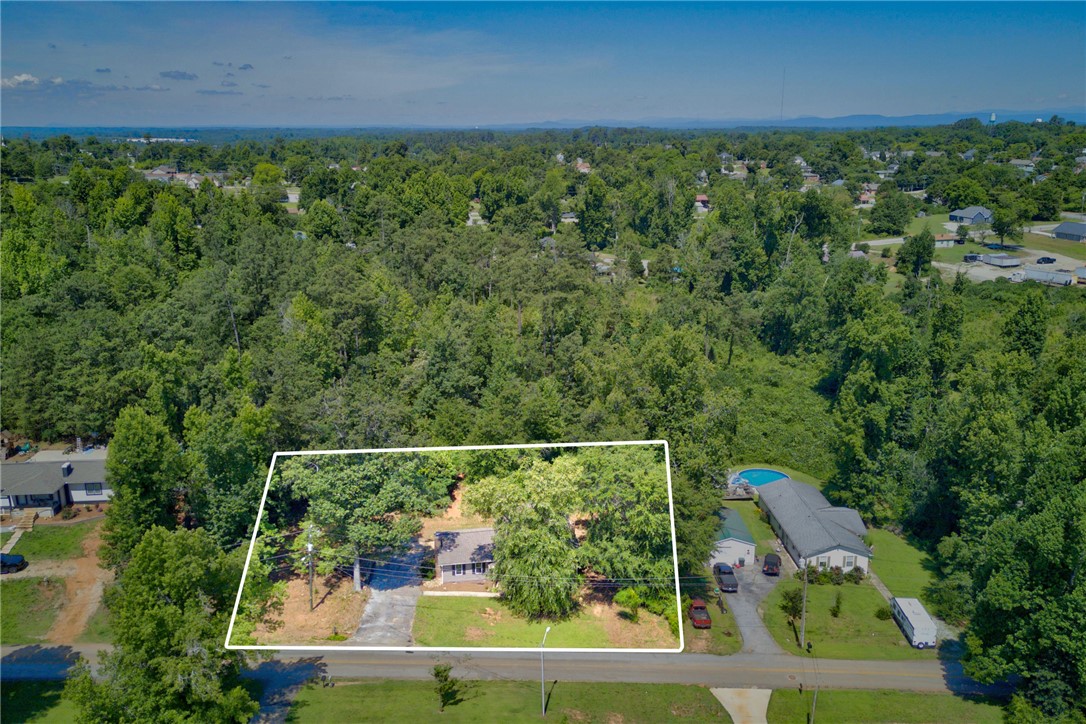 712 Beech Drive Seneca, SC 29678 - Photo 36 of 41 An aerial perspective reveals a secluded home, nestled amongst a vibrant, expansive woodland.