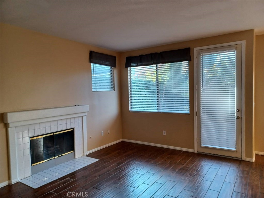 2018 Villa Del Lago Drive, Unit A Chino Hills, CA 91709 - Photo 2 of 10 an empty room with wooden floor fireplace and windows