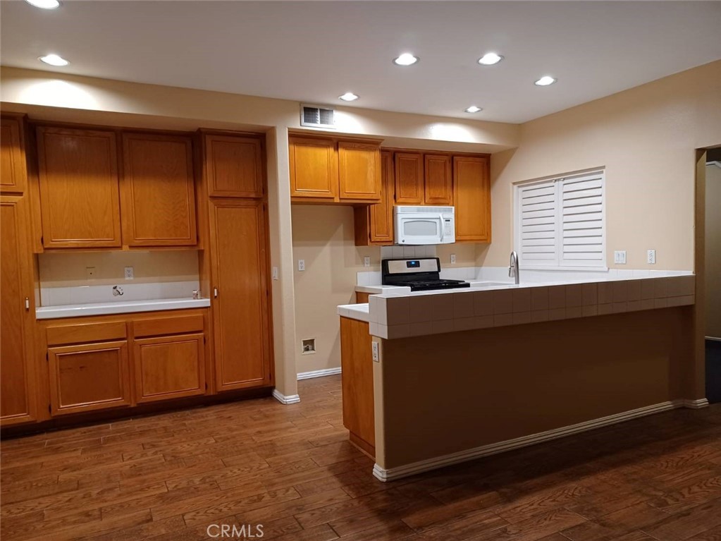 2018 Villa Del Lago Drive, Unit A Chino Hills, CA 91709 - Photo 3 of 10 a kitchen with stainless steel appliances granite countertop a refrigerator and a stove top oven