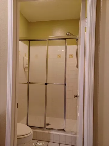 a bathroom with a glass shower door