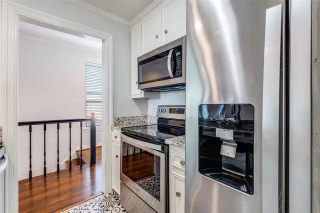 a kitchen with stainless steel appliances granite countertop a stove and a microwave