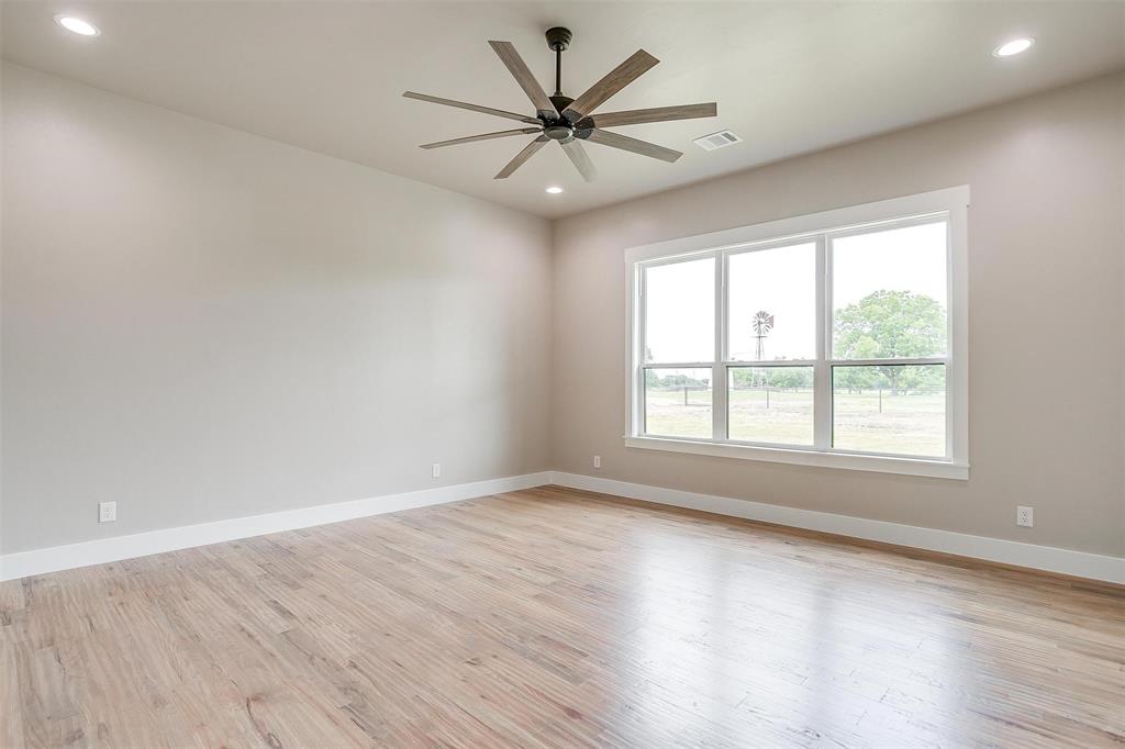 3019 Orchard Road Bowie, TX 76230 - Photo 27 of 40 an empty room with wooden floor and windows
