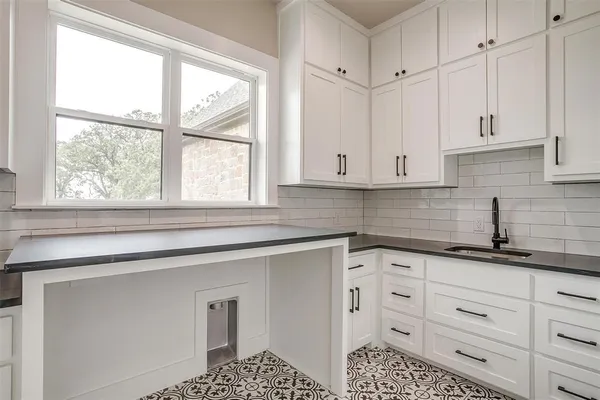 a view of a kitchen with large windows