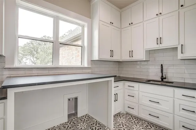 a view of a kitchen with large windows