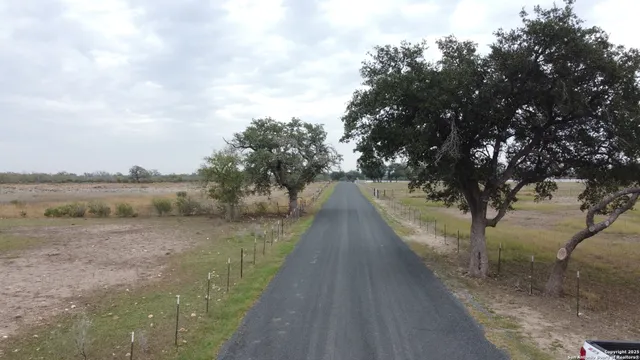 a view of a pathway with a wrought fence