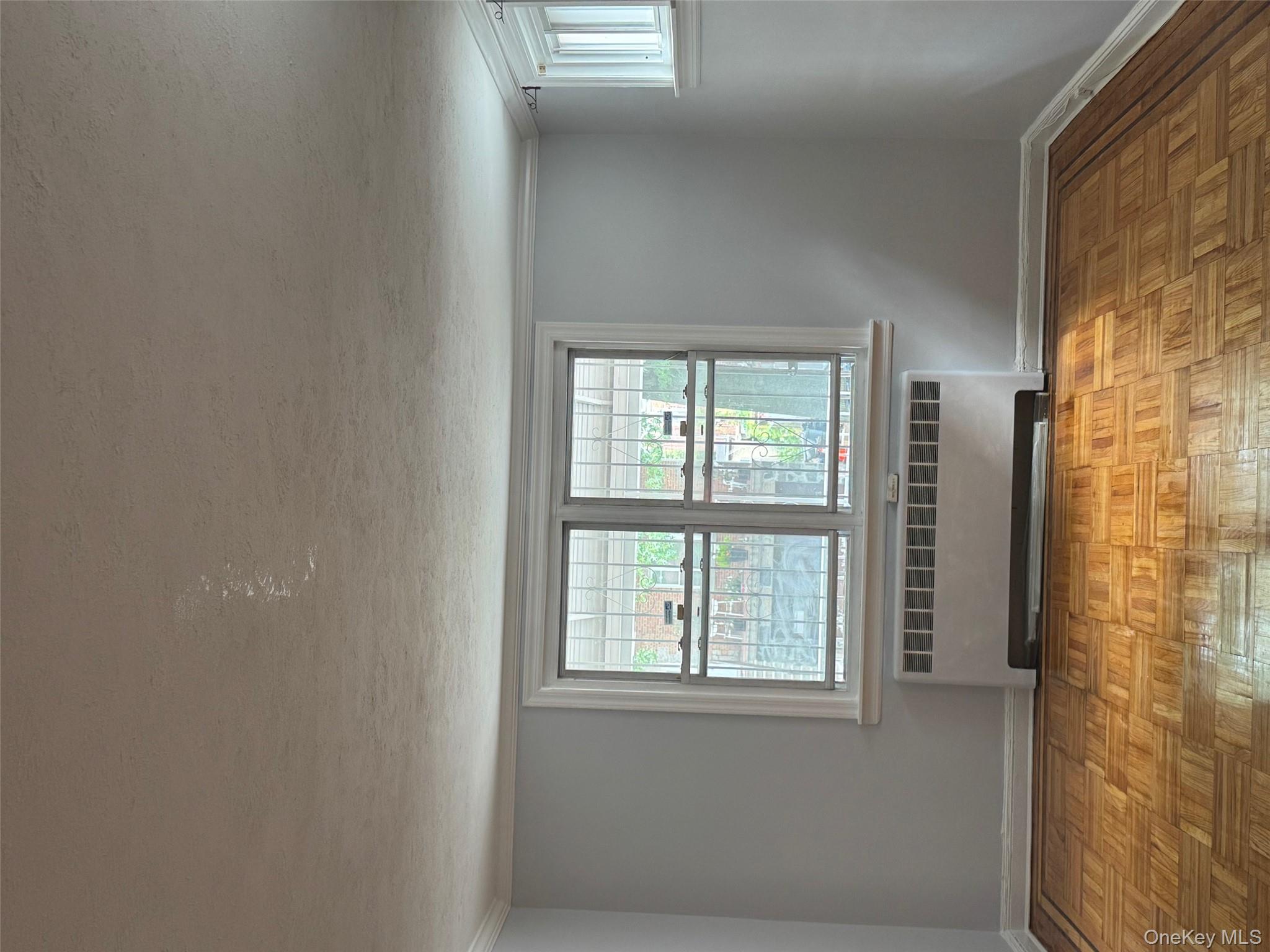 2339 Barnes Avenue Bronx, NY 10467 - Photo 11 of 16 an empty room with wooden floor