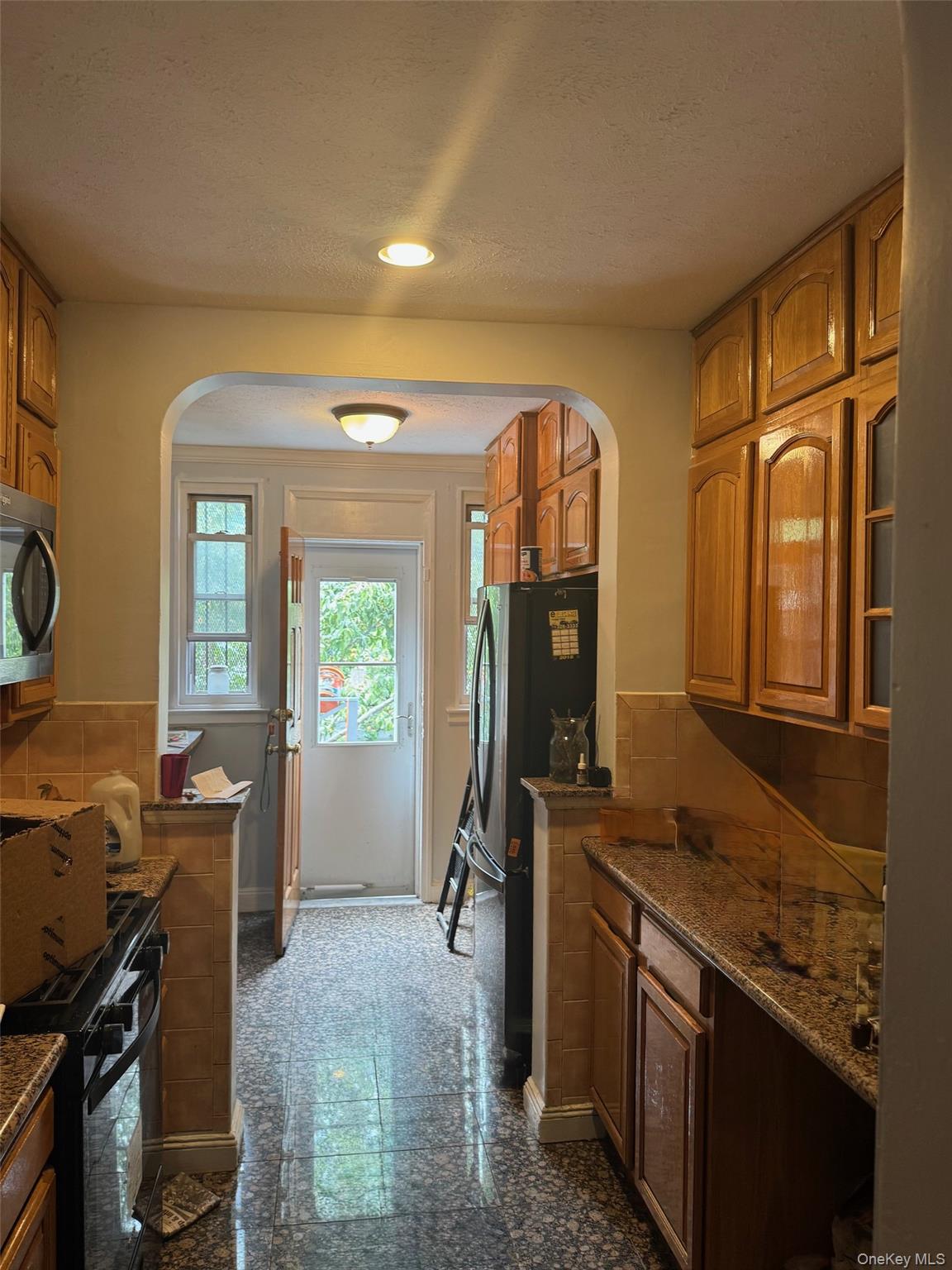 2339 Barnes Avenue Bronx, NY 10467 - Photo 12 of 16 a view of a kitchen with fridge and windows