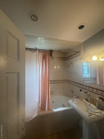 a bathroom with a tub and a sink