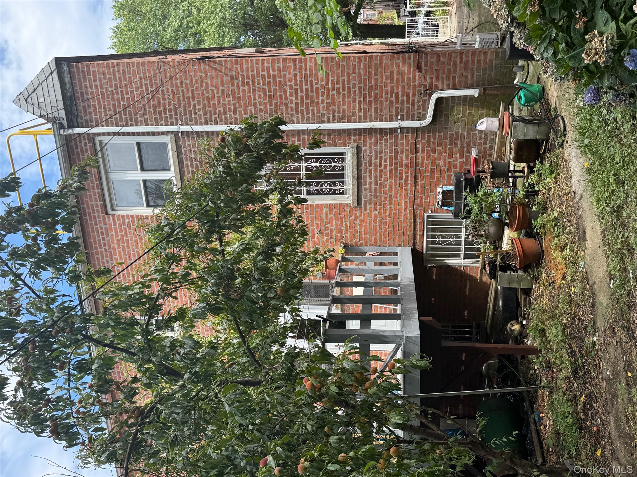 2339 Barnes Avenue Bronx, NY 10467 - Photo 3 of 16 a front view of a house with a garden