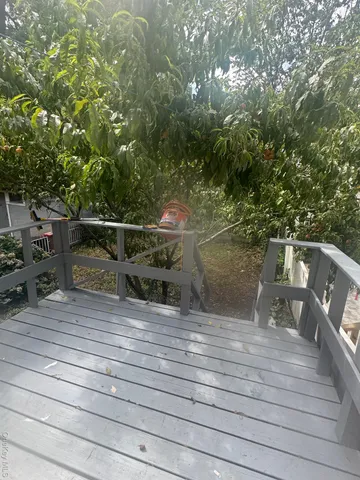 a view of a balcony with wooden floor