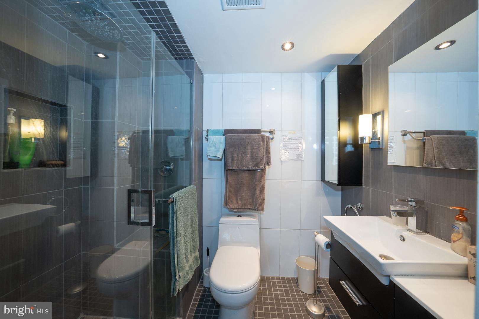 1919 Chestnut Street, Unit 1919 Philadelphia, PA 19103 - Photo 11 of 27 a bathroom with a toilet sink and shower