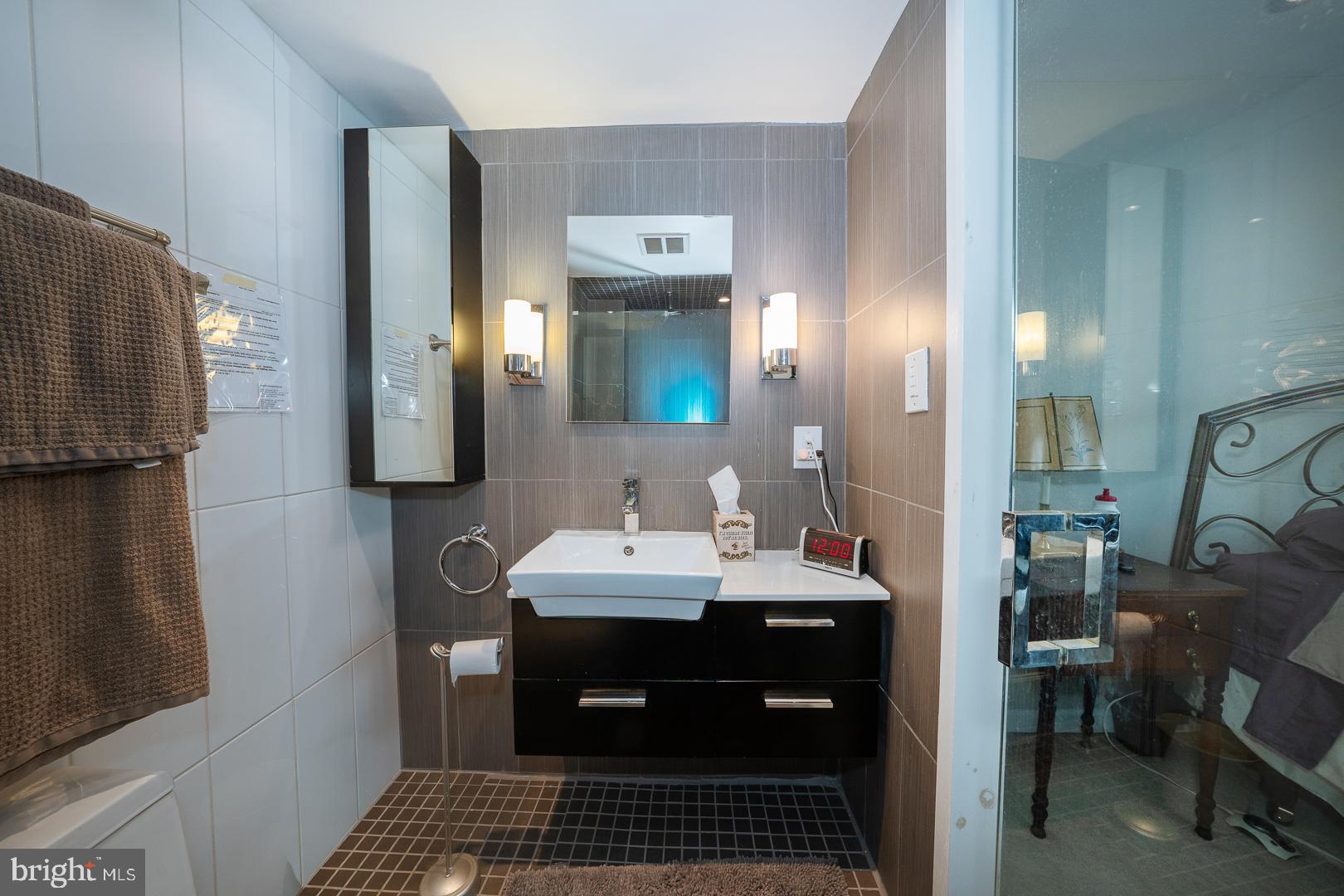 1919 Chestnut Street, Unit 1919 Philadelphia, PA 19103 - Photo 12 of 27 a bathroom with a sink and a mirror