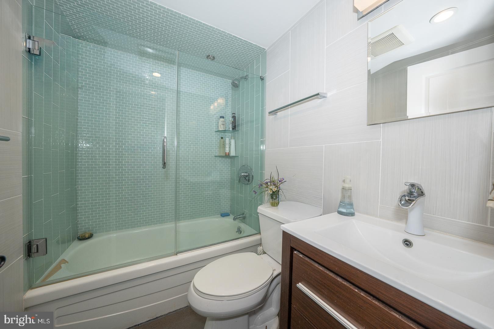 1919 Chestnut Street, Unit 1919 Philadelphia, PA 19103 - Photo 15 of 27 a bathroom with a sink a toilet and shower