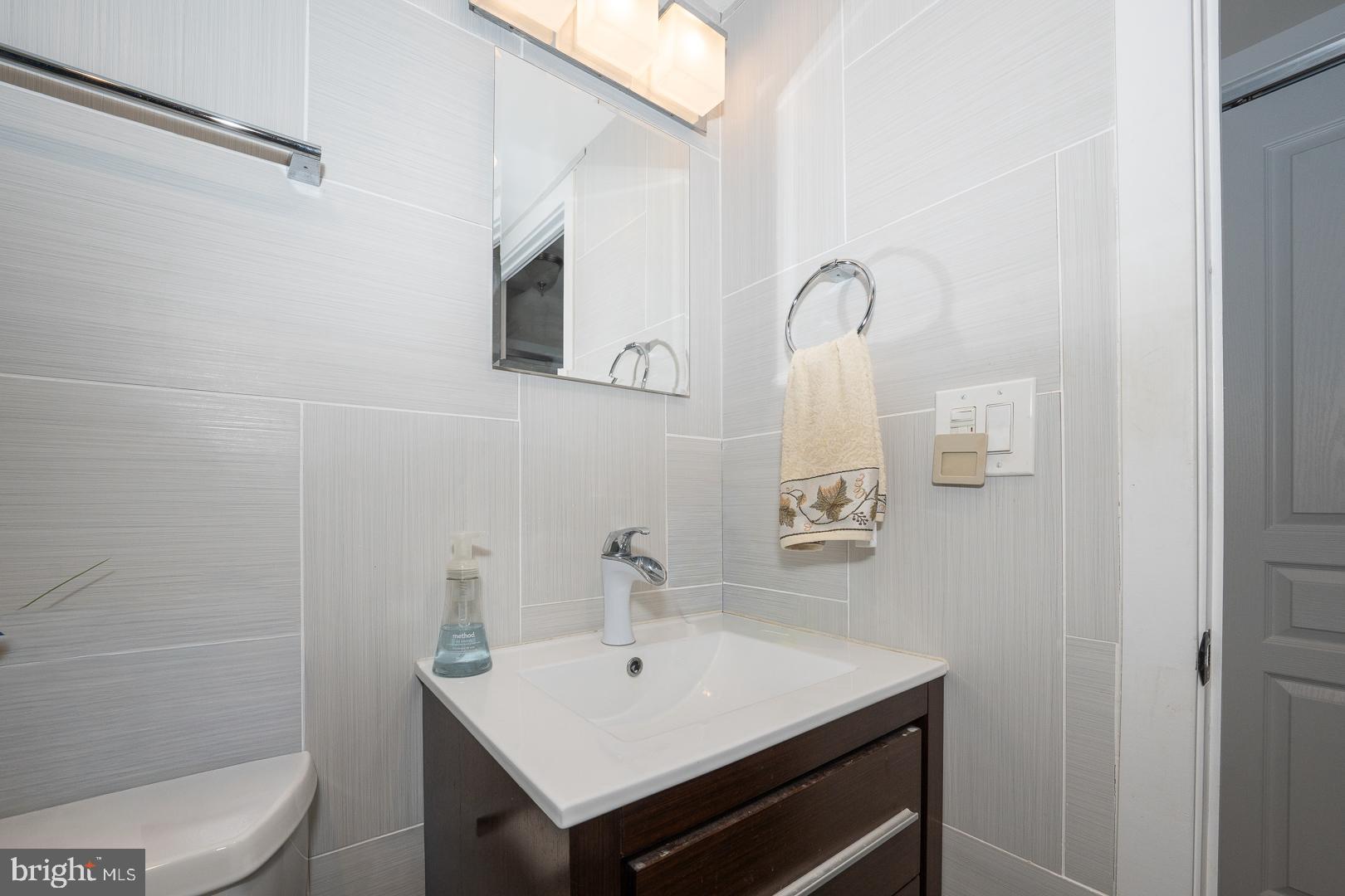 1919 Chestnut Street, Unit 1919 Philadelphia, PA 19103 - Photo 16 of 27 a bathroom with a sink toilet and mirror
