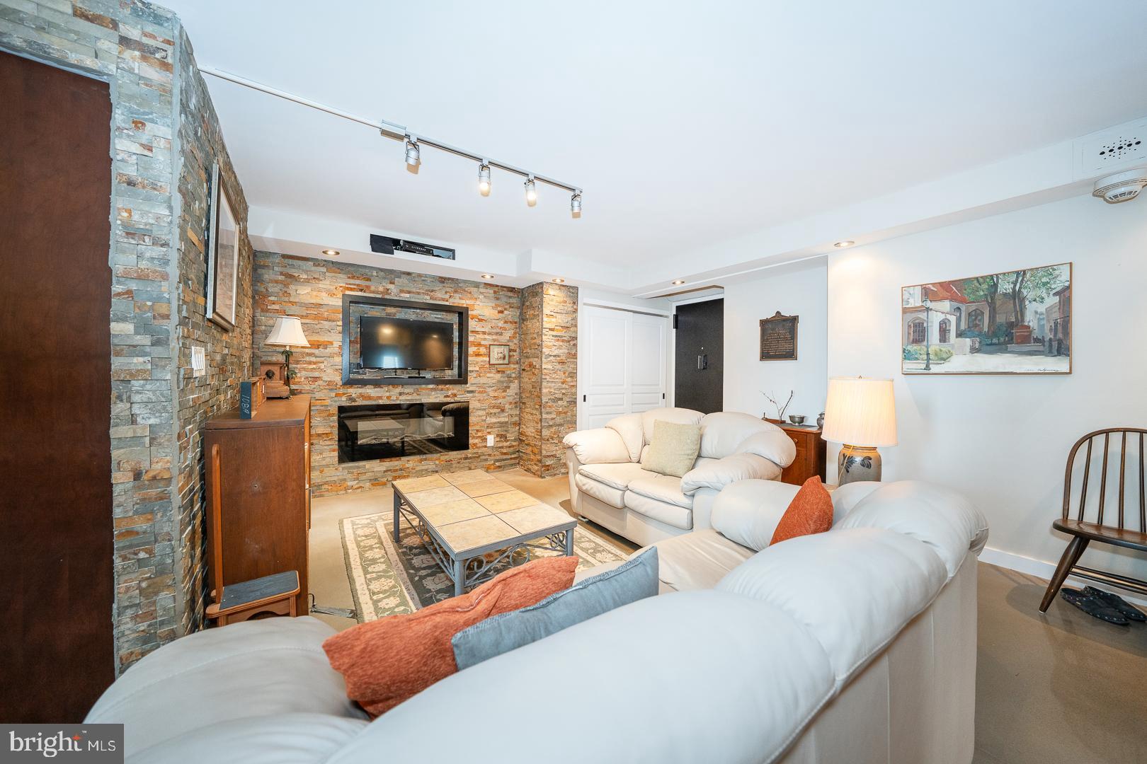 1919 Chestnut Street, Unit 1919 Philadelphia, PA 19103 - Photo 2 of 27 a living room with furniture and a flat screen tv