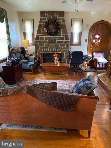 a living room with fireplace furniture and a flat screen tv