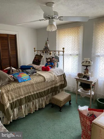 a bedroom with bed and window