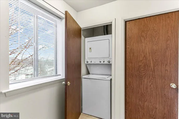 an empty room with a cabinet and mirrors