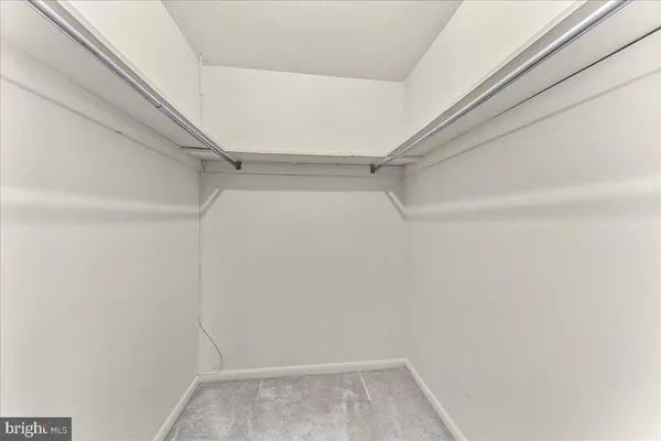 a bathroom with a granite countertop toilet sink and mirror