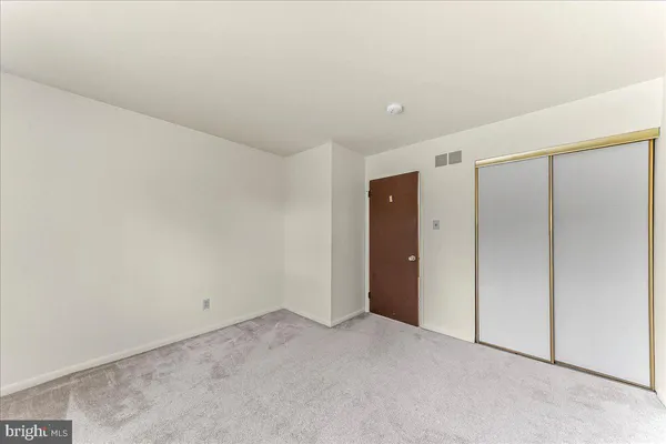 a view of an empty room with stairs