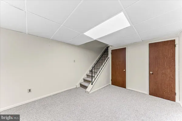 a bathroom with a granite countertop sink and mirror