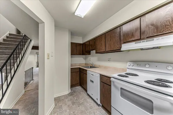 a kitchen with stainless steel appliances granite countertop a stove and a refrigerator