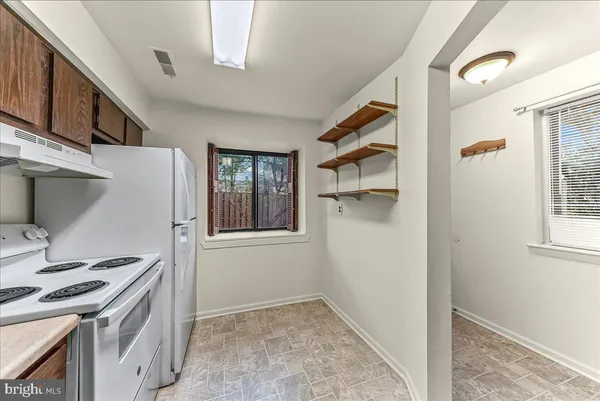 a kitchen with a stove and a refrigerator